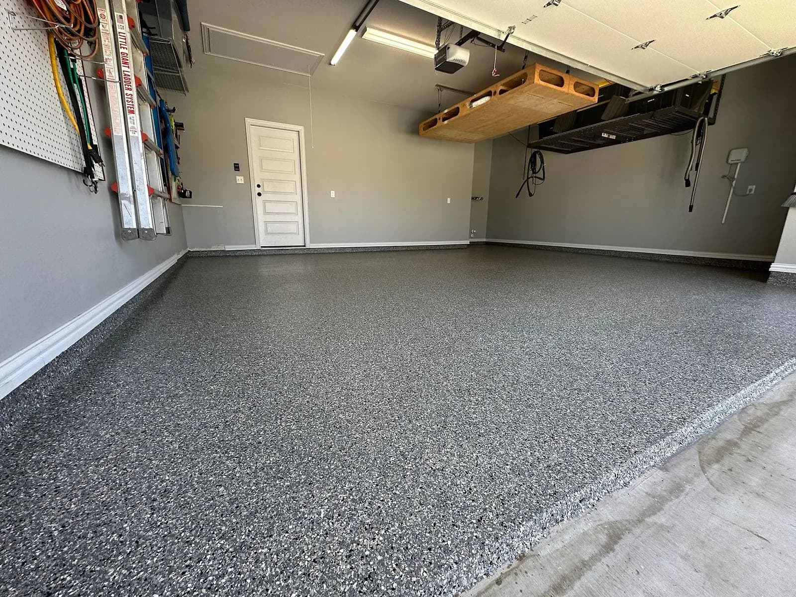 Wide view of a finished flake garage floor toward the garage door