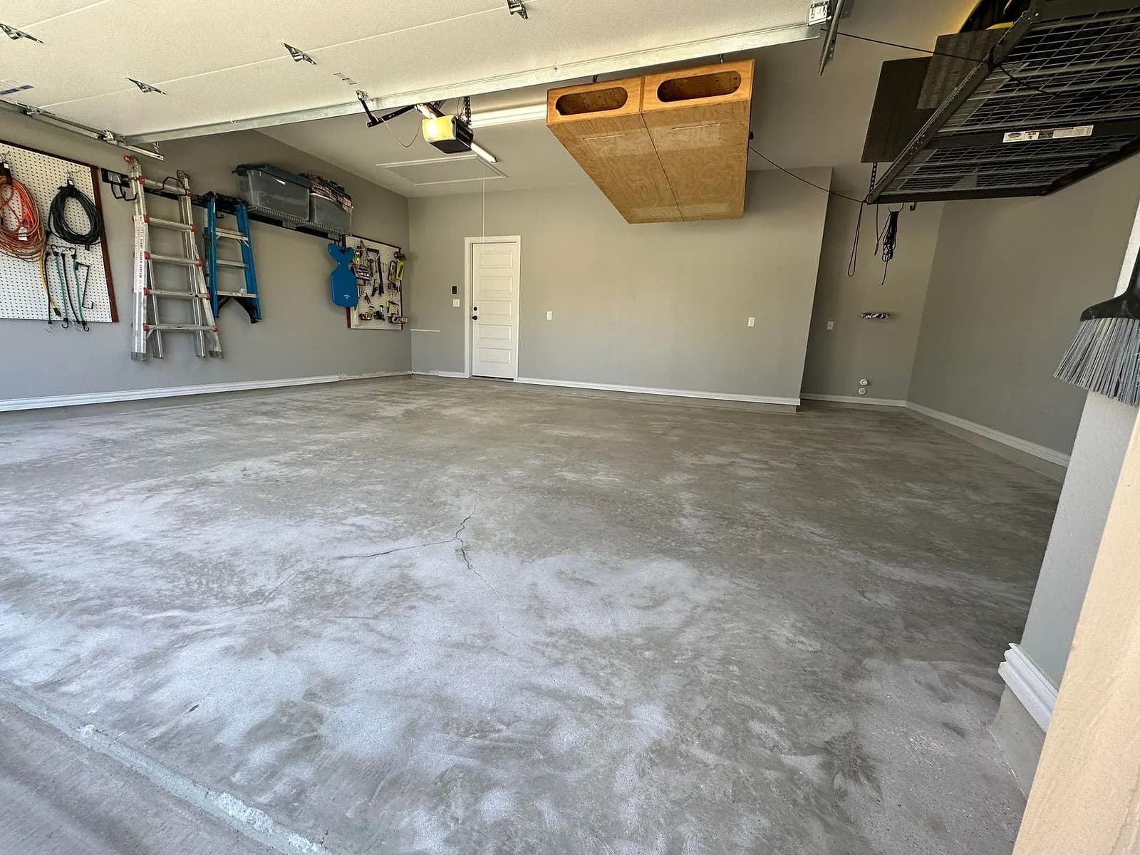 Garage before coating: bare, blotchy grey concrete