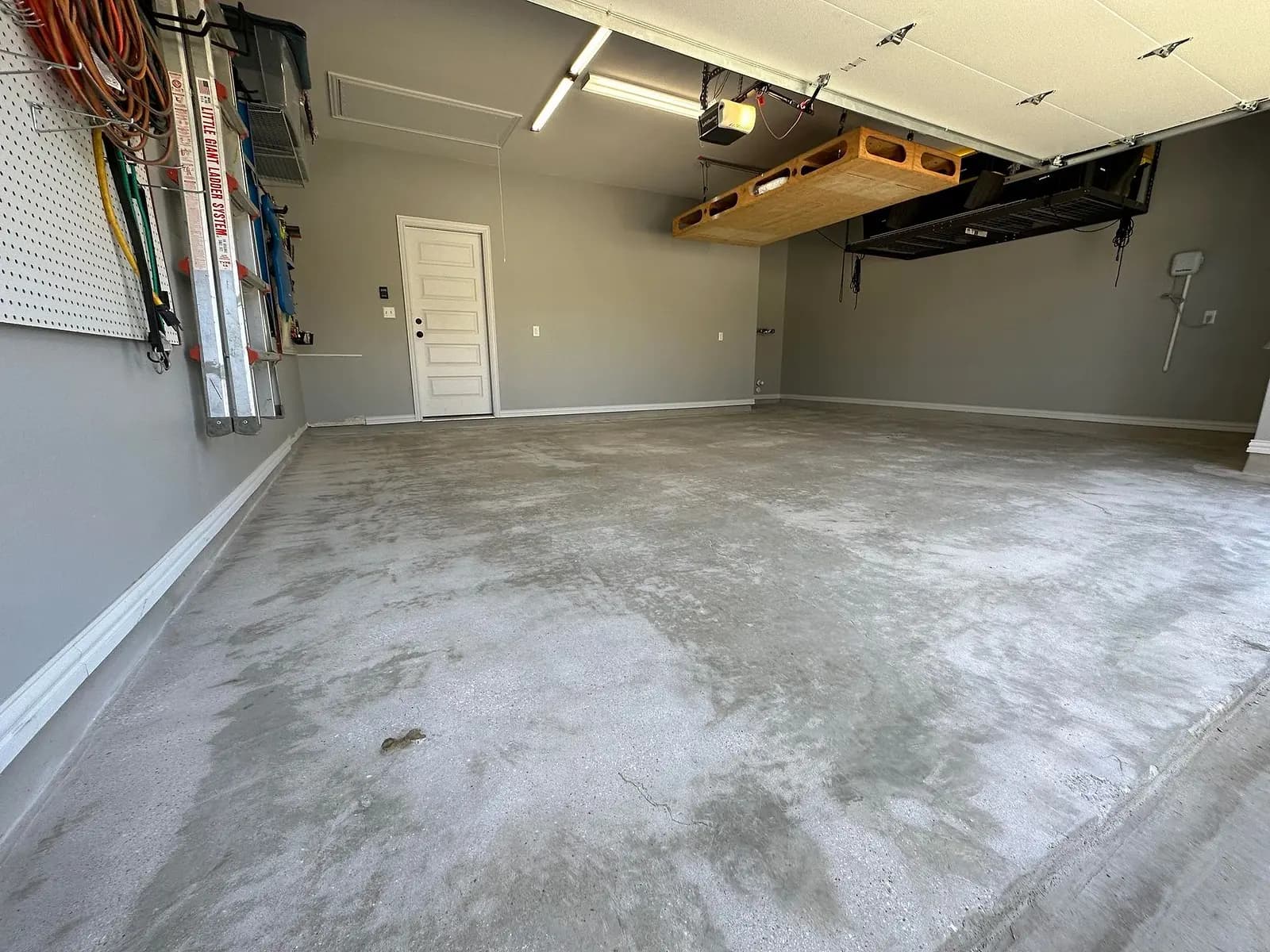 The same garage before coating, stained concrete along the wall