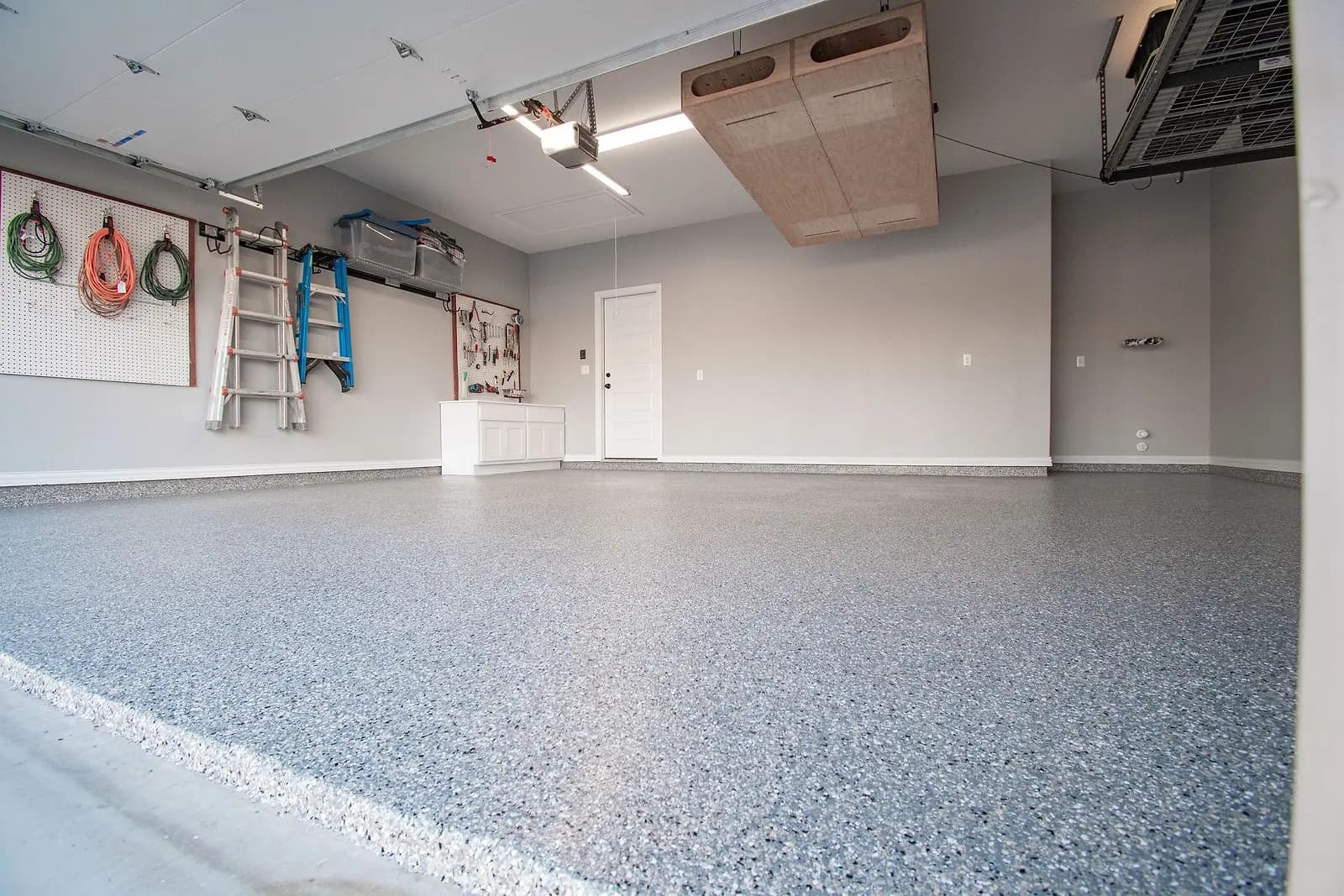 Coated garage floor reflecting the ceiling lights
