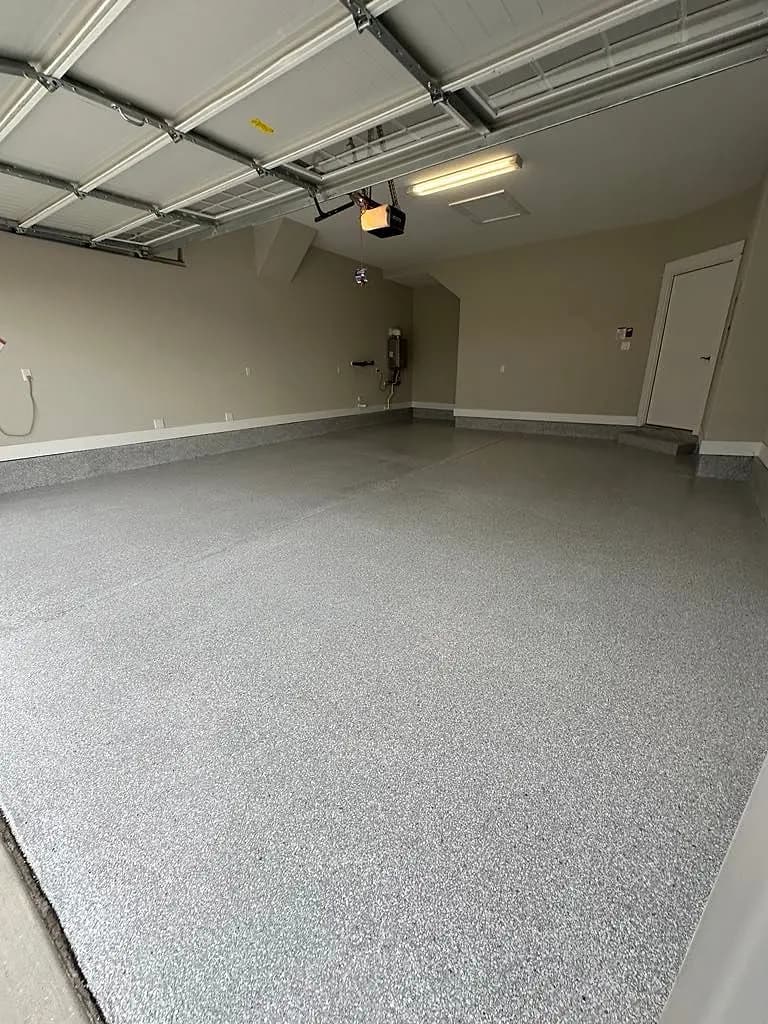 Coated garage floor seen from the house door toward the open garage door