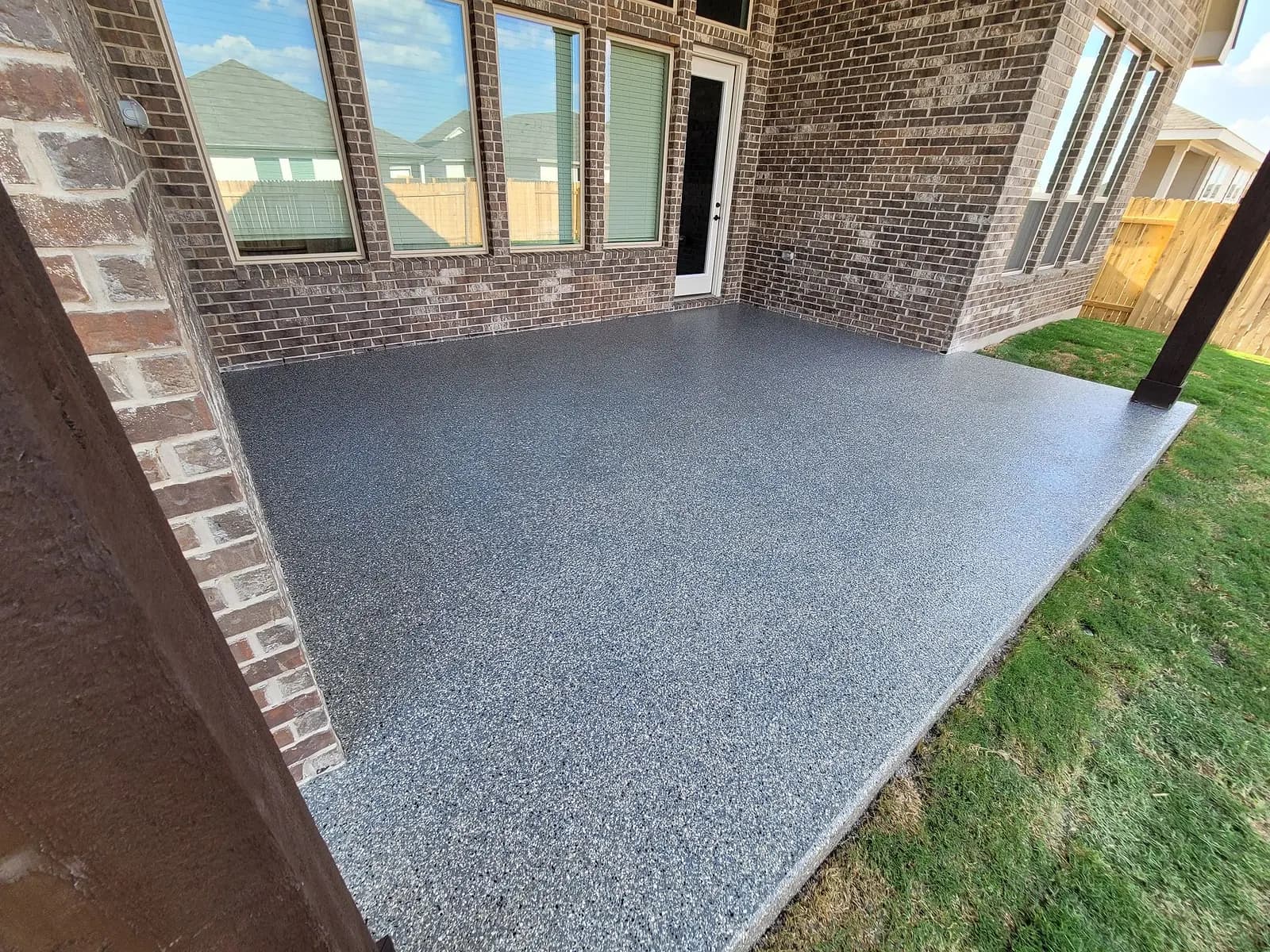 Corner of a coated patio where it meets the lawn