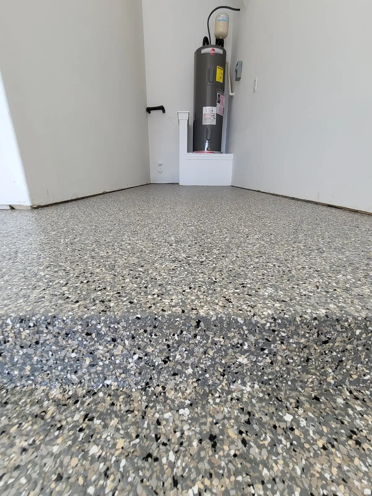 Coated patio edge beside a garage wall