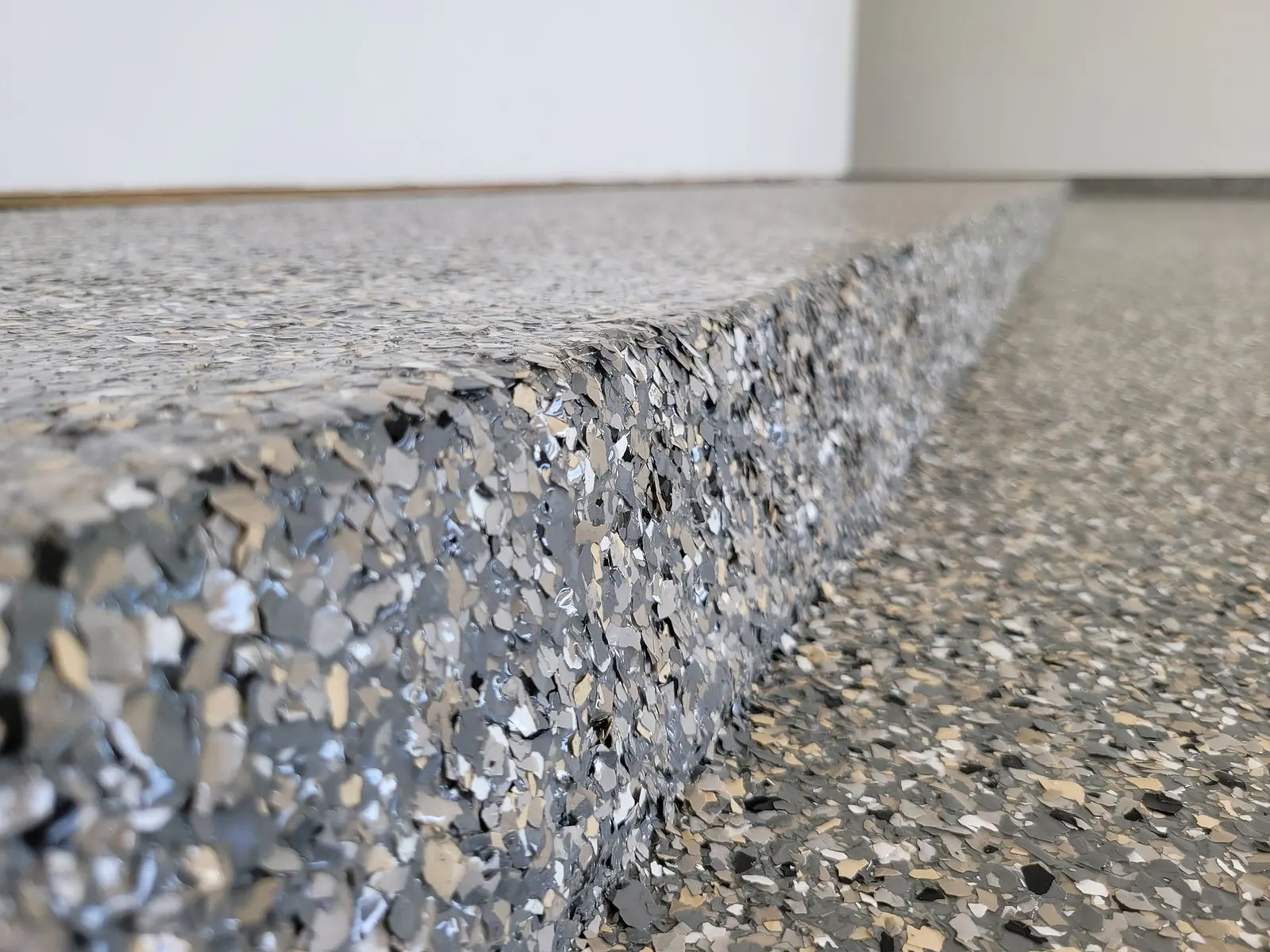 Close-up of the flake coating on a patio slab's edge