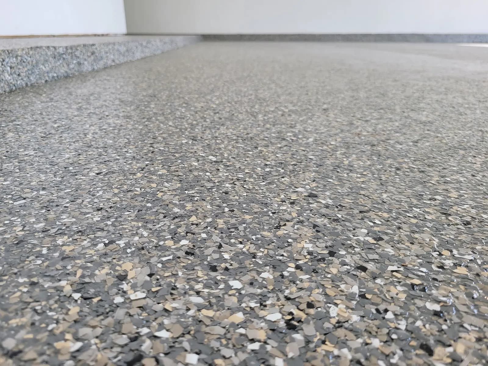 Flake coating wrapped over the edge of an outdoor concrete slab