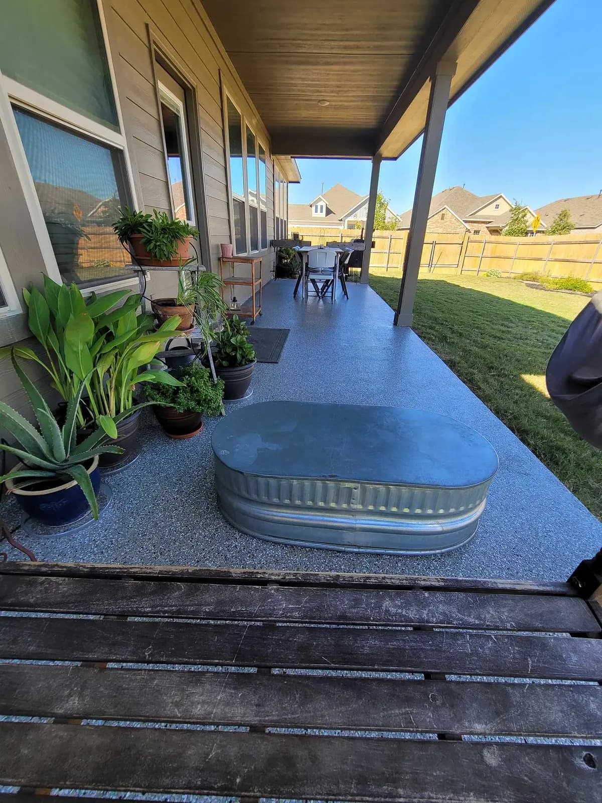 Covered porch lined with planters on a flake coating